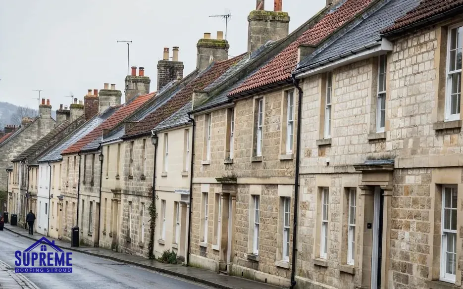 Street of stone terraced houses with slate and clay tile roofs